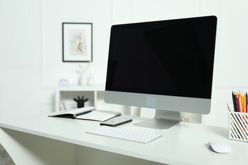 Wall Mural - Modern workplace with computer and stationery on white desk indoors