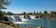 © JKLoma - A brilliant blue sky above the waterfalls of Idaho Falls, sunny day, clear blue, blue sky