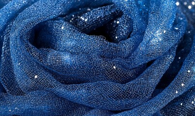 Blue glitter fabric draped and swirled, ideal for textile, fashion, or craft projects.