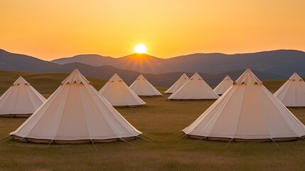 Poster - Sunset view of many white canvas tents on a grassy field with mountains in the background.