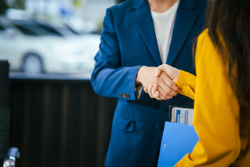 Wall Mural - A businessman and businesswoman shake hands during a meeting at the office,signifying collaboration.They discuss strategies, agreements,opportunities to drive business growth strengthen professional