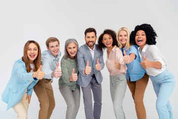 Diverse group of professionals showing thumbs up on light background symbolizing teamwork and success