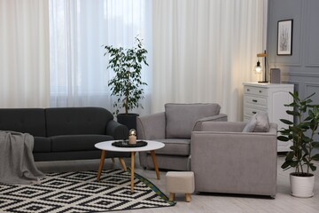 Poster - Comfortable couch, armchairs and coffee table in living room. Interior design