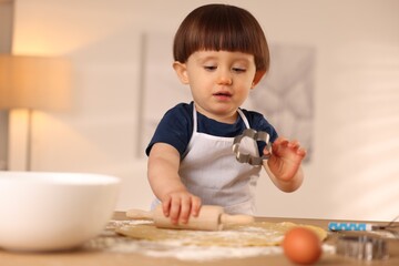 Canvas Print - Cute little with rolling pin and cookie cutter at table indoors