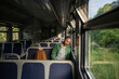 © DimaBerlin - Sleepy man worn out from demanding workday, naps on an empty train ride home. Tired male backpacker on public transit, urban travel, daily exhaustion and early rise, week commute, train journey alone