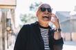 © BullRun - Happy male laughing while speaking on cellphone