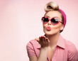 © L_K - Creative concept photo of young woman with pin up retro vintage hairstyle and heart shaped sunglasses sending kiss love.