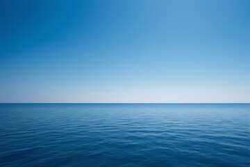 Wall Mural - arafly view of a calm ocean with a clear blue sky