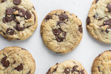 Wall Mural - Overhead view of chocolate chip cookies on a cooling rack, top view of homemade chocolate chip cookies on a white background