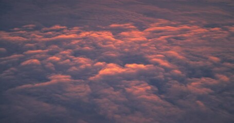Wall Mural - flying with plane in sky of color clouds and sunlight of sunset or sunrise fluffy scenic cloudscape 