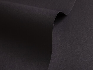 Poster - Charcoal black paper background with curved, matte surfaces and a grainy texture. Bold dark tones and a dynamic, polished design create a dramatic, sophisticated, and refined composition.