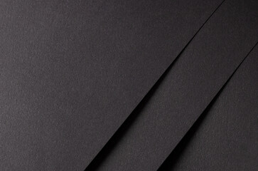 Poster - Charcoal black paper background with smooth, matte textures and overlapping layers. Bold dark tones and a grainy finish create a dramatic, stylish, and refined composition.