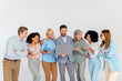 © deagreez - Diverse team collaboration discussing new ideas, featuring professionals in formalwear gathered around a laptop