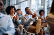 © Drazen - Happy black businessman and his colleagues applauding after successful business conference.