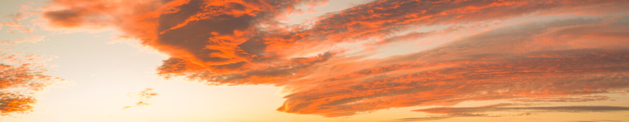 Wall Mural - Panoramic orange sky. Red view of the clouds after sunset or sunrise  in the evening. Calm atmosphere in the evening.