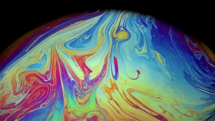 Wall Mural - Closeup video of a soap bubble showing thin film interference concept and resulting different spectrum of light with bursting moment at the end