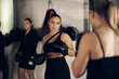 © Flamingo Images - Fit young woman in sportswear holding pads during punching practice with a female friend during a boxing session together at the gym