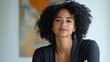 © Kenny - Confident african female adult with curly hair and black outfit