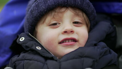 Baby toddler on stroller wearing winter clothing