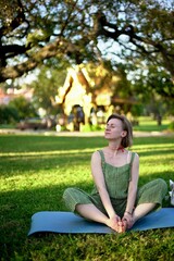 woman sitting on a bench in park. Meditation. City park.