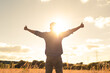 © kieferpix - Happy joyful man feeling positive standing in the sunlight in a field