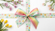 © VerraDesigns - A pastel rainbow bow with a floral-themed ribbon arranged on a white background, complemented by fresh pink and yellow flowers placed decoratively around. This festive and cheerful design is perfect f