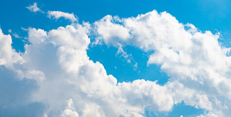 Wall Mural - blue sky with a few clouds. The sky is very bright and the clouds are scattered throughout. Beautiful cloud in blue sky. White fluffy clouds in the sky.