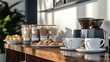 © Watanabe - An elegant coffee station in the office break room with a selection of mugs and snacks for employees.
