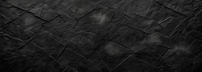 Poster - A textured black stone wall creates a dramatic backdrop, showcasing intricate patterns and a sense of depth. Perfect for adding a bold touch to any design or architectural project.