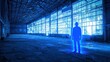 © BlackBird Studio - A haunting silhouette stands in a vacant warehouse illuminated by blue light, evoking feelings of solitude and mystery.