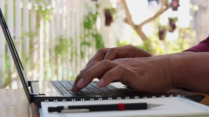 Poster - Close-up of the man's hand is typing on a laptop computer keyboard at home or in the office. He is working, sending messages, chatting, browsing the internet, and using social networking.