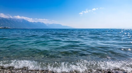 Aufkleber - Clear Blue Ocean Waves Lapping Against a Rocky Shoreline Under Open Skies : Generative AI