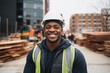 © Baba Images - Smiling portrait of a young male African American construction worker on site