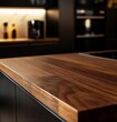 © Abusufyan - Close-up of a sleek, dark brown wood countertop in a modern kitchen.