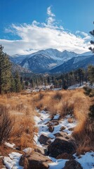 Wall Mural - A peaceful mountain view with snow-capped peaks, soft clouds floating across the sky, and the quiet serenity of the natural landscape.