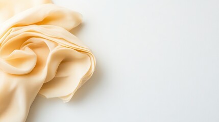 Poster - Soft cream fabric with delicate folds on a light background, ideal for backgrounds, textiles, fashion design, and artistic styling in photography projects.