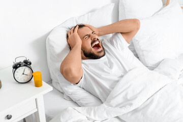 Sticker - Stressed young man lying in bedroom