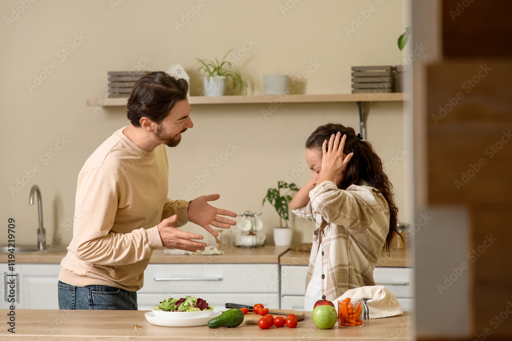 Angry ma shouting at his wife in kitchen. Divorce concept