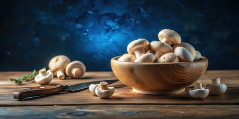 Poster - A rustic wooden bowl brimming with fresh, button mushrooms sits on a weathered wooden table, accompanied by a few additional mushrooms and a kitchen knife.