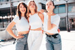 © halayalex - Three young beautiful smiling hipster female in trendy summer white t-shirt  and jeans clothes. Sexy carefree women posing in street. Positive models having fun, going crazy. In sunny day