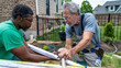 © INT888 - Homeowner consulting with contractor on plumbing installation options