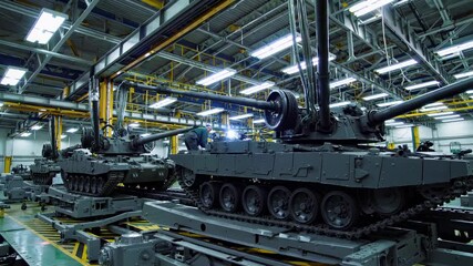 Leinwandbilder - Tanks undergo assembly and inspection in a large military manufacturing facility