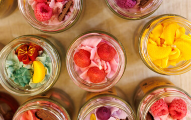 Wall Mural - A row of jars filled with colorful candies and fruits