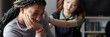 © Seventyfour - Header style image of Black teenage girl crying during support group session with caring friend comforting her in blurred background copy space