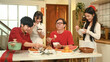 © Prathankarnpap - Chinese family enjoying a delicious Chinese New Year feast at cozy home