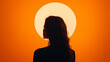 © Keitma - A serene silhouette of a woman outlined against an orange sky, framed by a luminous circular sun, creating a striking and evocative composition.