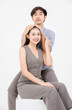 © Bangkok Click Studio - Portrait of young asian happy attractive cheerful couple love, Joyful sweethearts hugging embracing cuddle enjoy good time romantic date, posing to camera smiling sitting together on white background