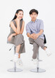 © Bangkok Click Studio - Portrait of lovely young asian happy attractive cheerful couple love, Joyful sweethearts enjoy good time romantic date, sitting on stools posing to camera smiling against together on white background.