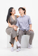 © Bangkok Click Studio - Portrait of lovely young asian happy attractive cheerful couple love, Joyful sweethearts enjoy good time romantic date, sitting on a box posing to camera smiling against together on white background.