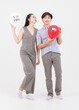 © Bangkok Click Studio - Portrait of young asian happy attractive cheerful couple love Joyful sweethearts holding air balloons for Valentine's day enjoy good time romantic posing to camera smiling standing on white background